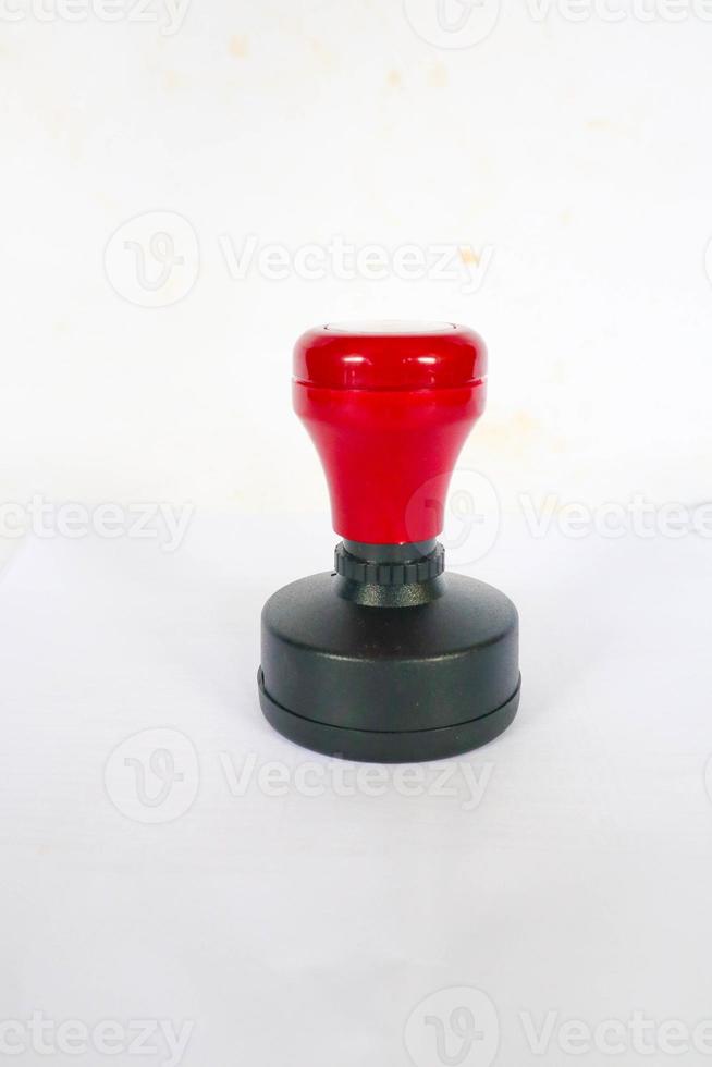 Stamp, modern Stamp, Red Handle Rubber Stamp Top View Isolated on White Background. photo