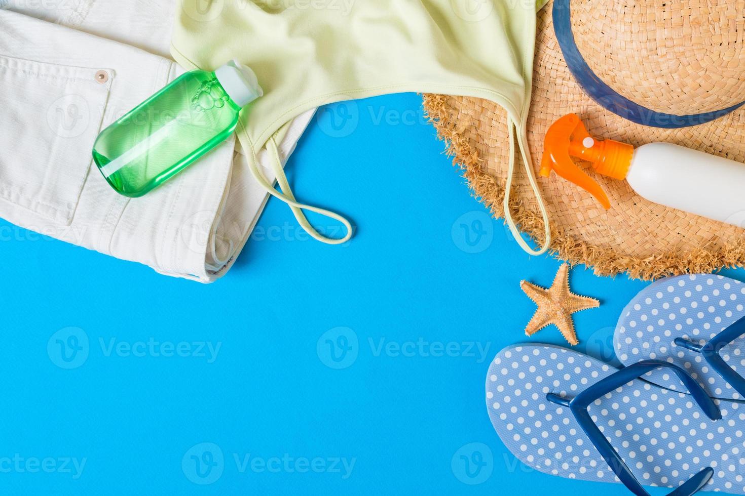 Woman summer outfit top view on blue background. Fashion vacations concept photo