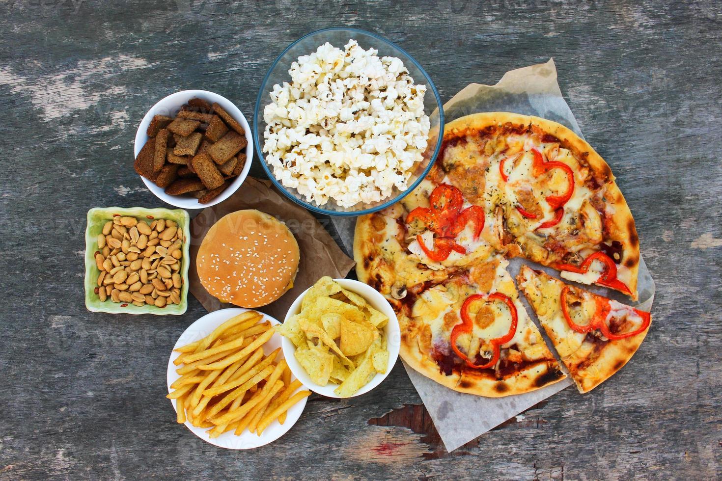 Fast food on old wooden background. Concept of junk eating. Top view. Flat lay. photo