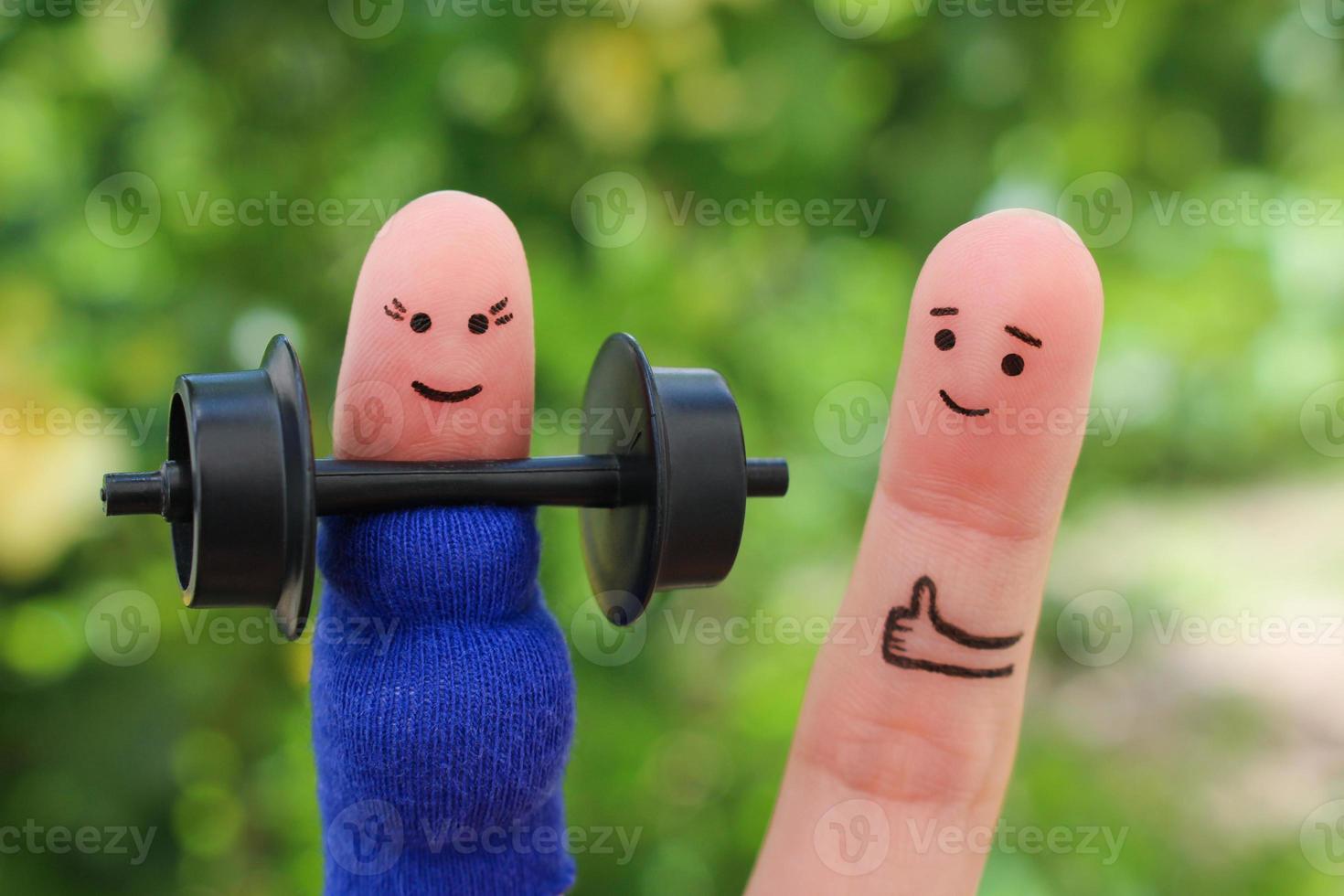 Fingers art of happy couple. Concept of pregnant woman doing sports and man supports her. photo