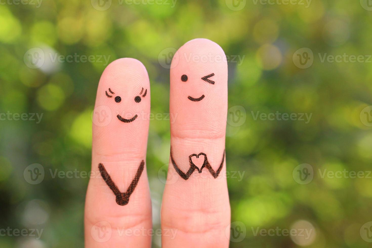 Fingers art of happy couple. Boyfriend showing fingers in heart shape. Concept of declaration of love. photo