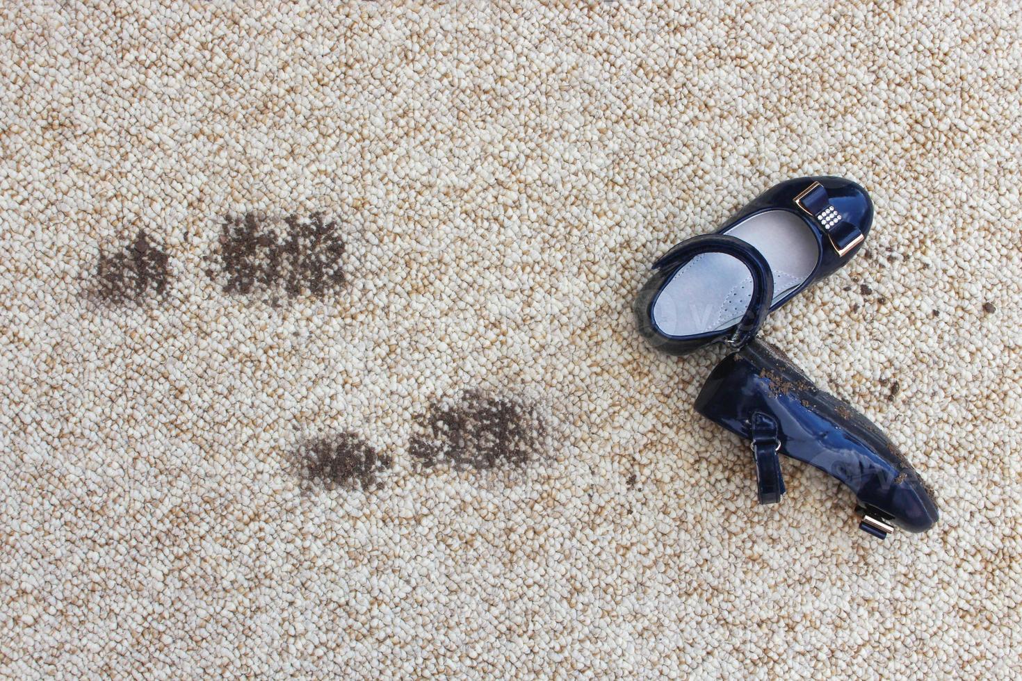 Dirty floor and children's shoes. Concept of child soiled carpet. photo