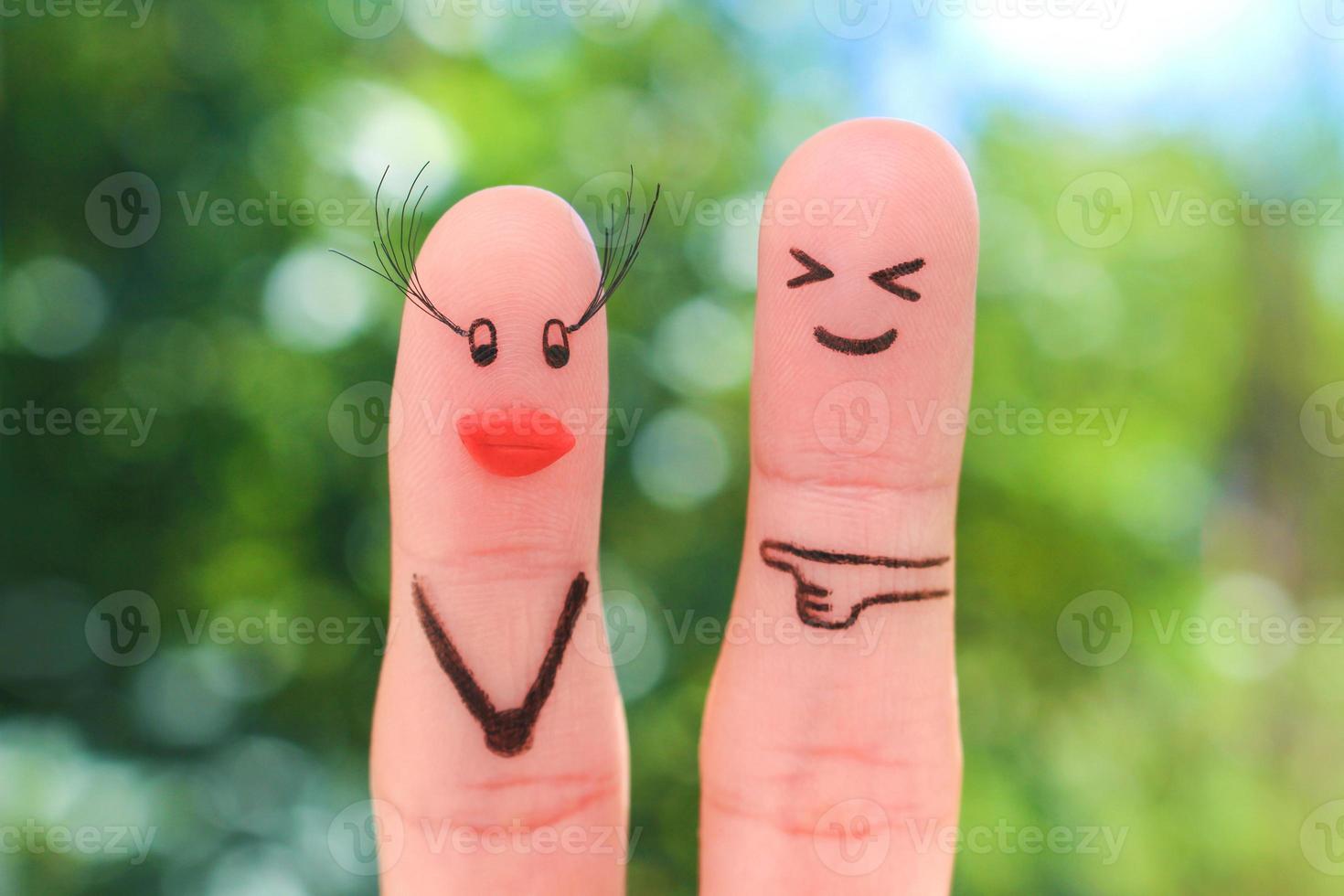 Fingers art of couple. Man does not like how woman has increased eyelashes, silicone lips. photo