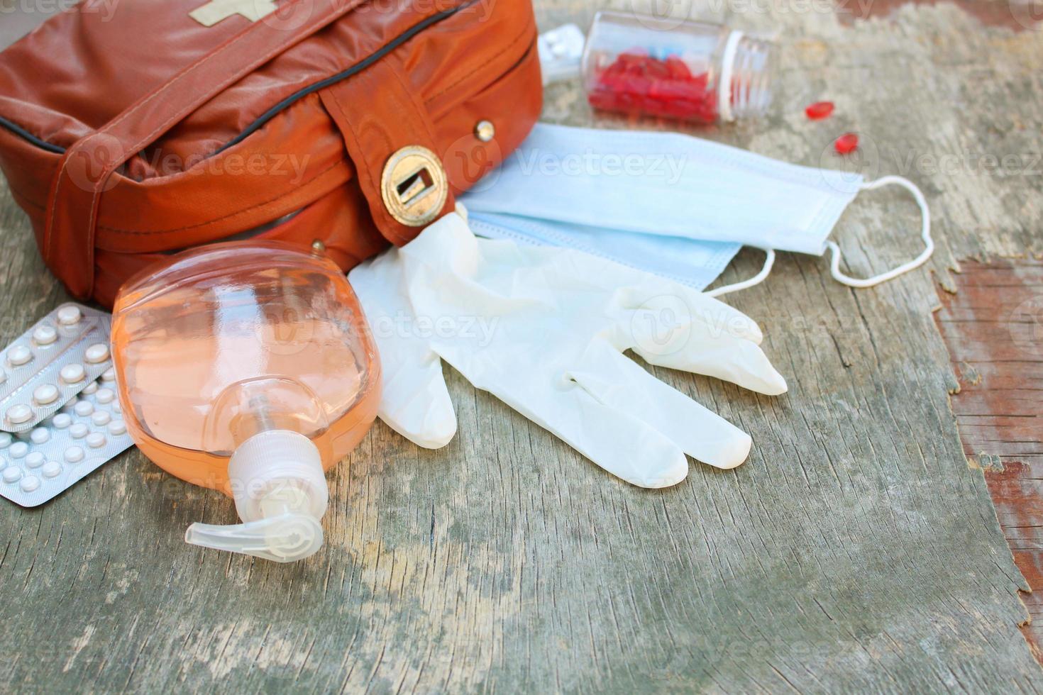 First aid kit on wooden background. Concept of protect yourself from COVID-2019. photo