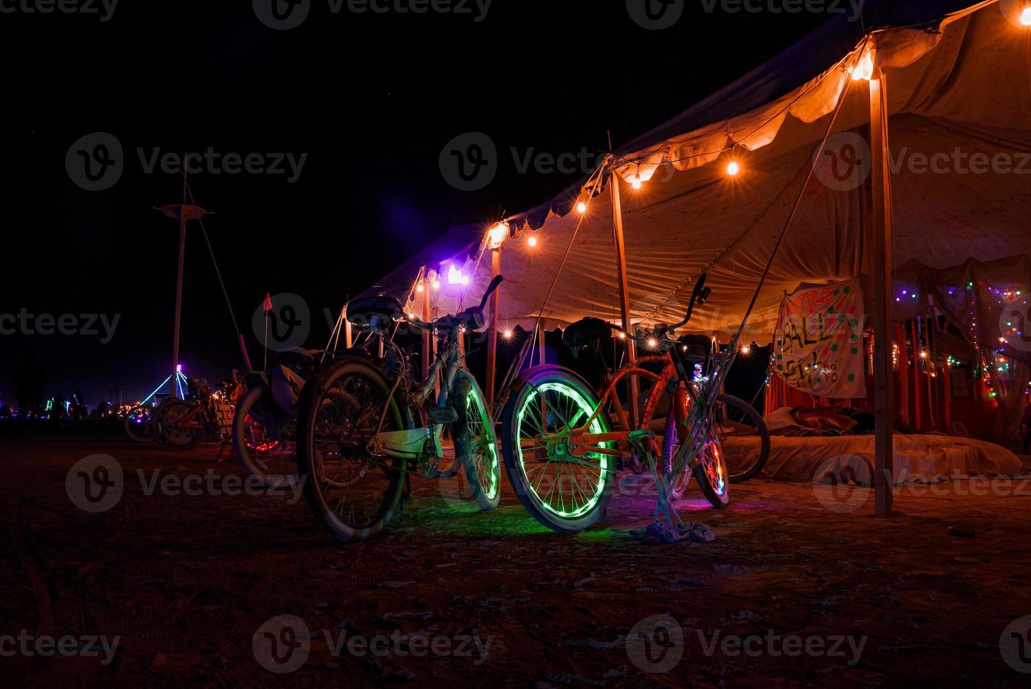 People walking towards sunset at a festival in the desert at the Burning Man Festival. photo