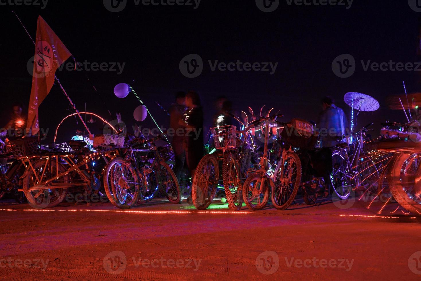 People walking towards sunset at a festival in the desert at the Burning Man Festival. photo