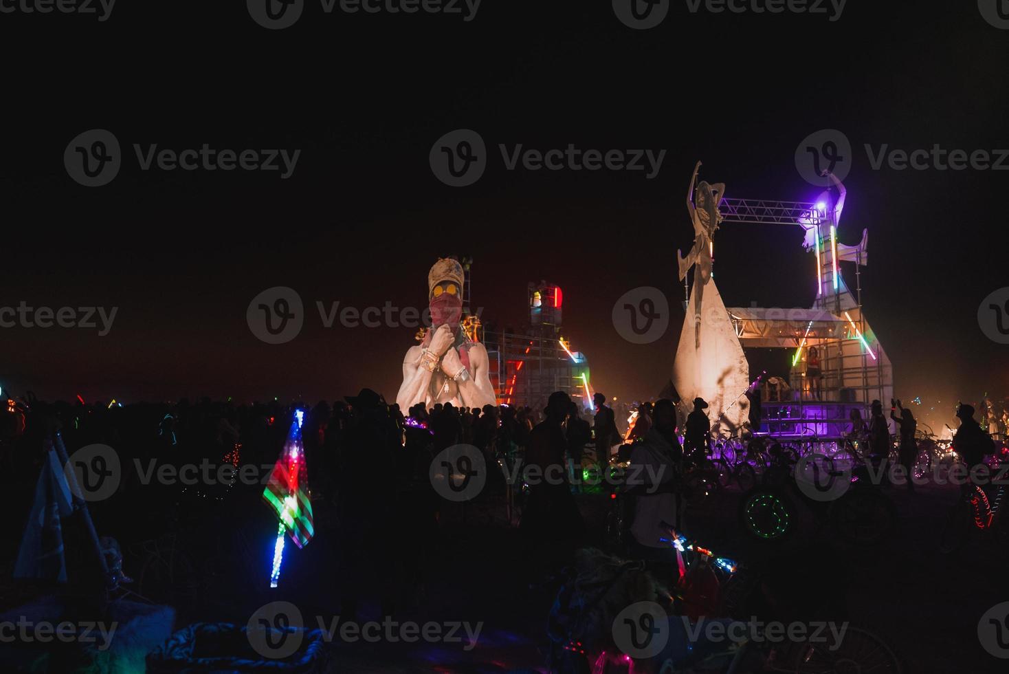 People walking towards sunset at a festival in the desert at the Burning Man Festival. photo