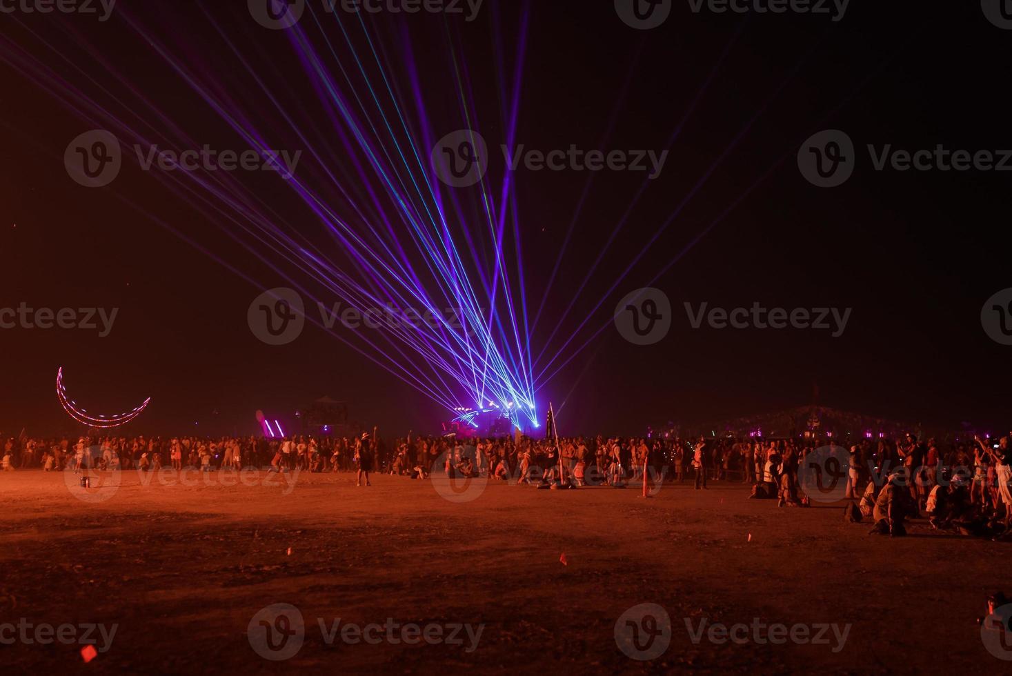 People walking towards sunset at a festival in the desert at the Burning Man Festival. photo