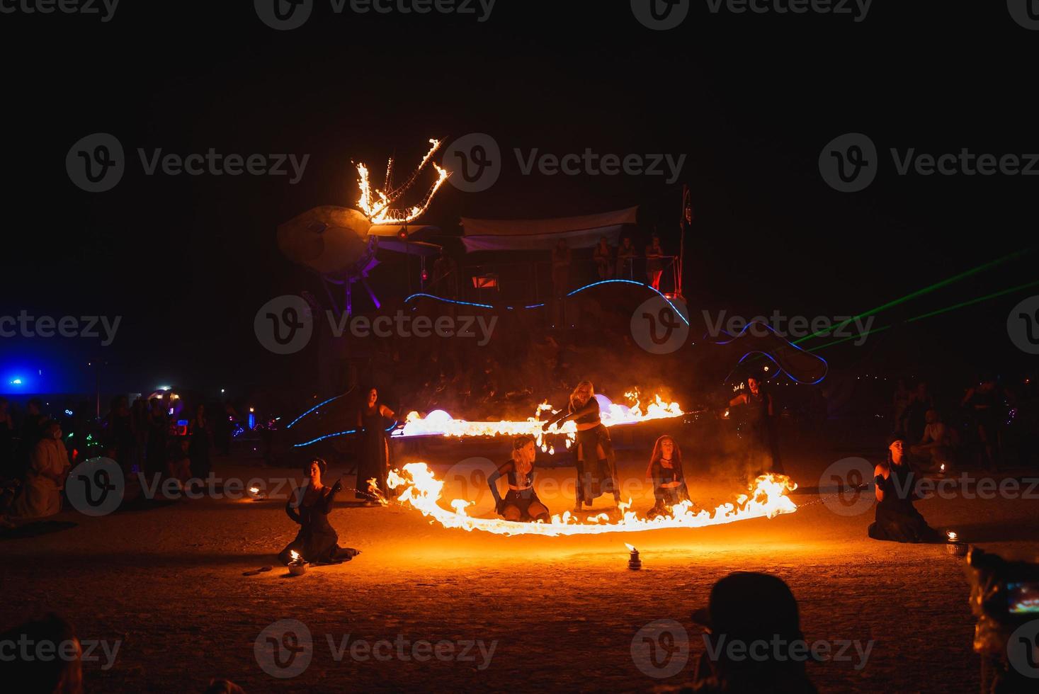 People walking towards sunset at a festival in the desert at the Burning Man Festival. photo