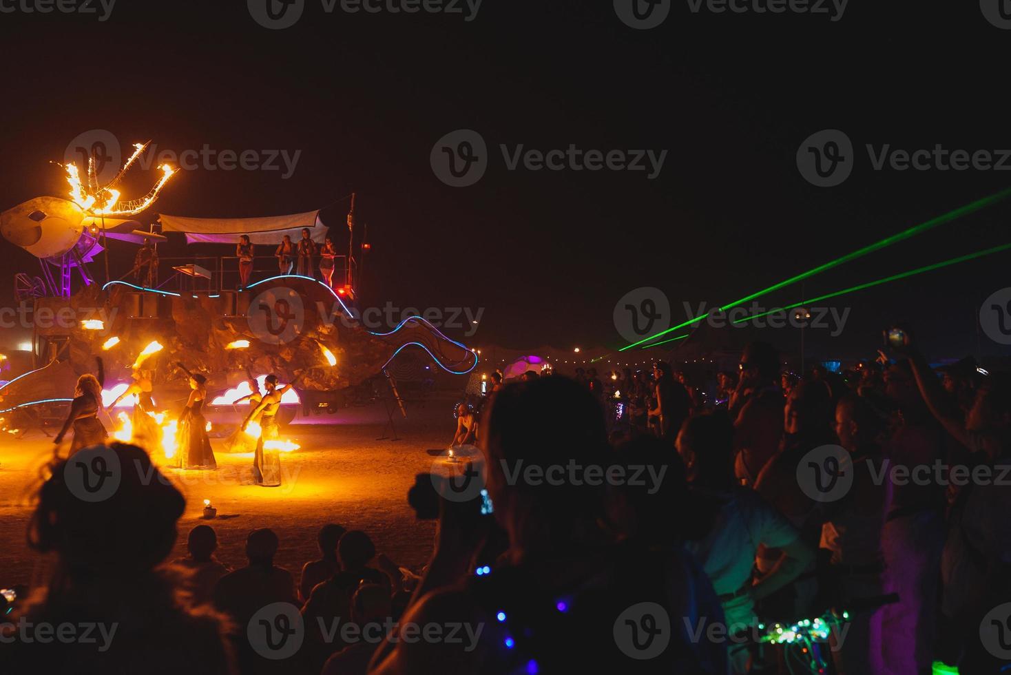 People walking towards sunset at a festival in the desert at the Burning Man Festival. photo