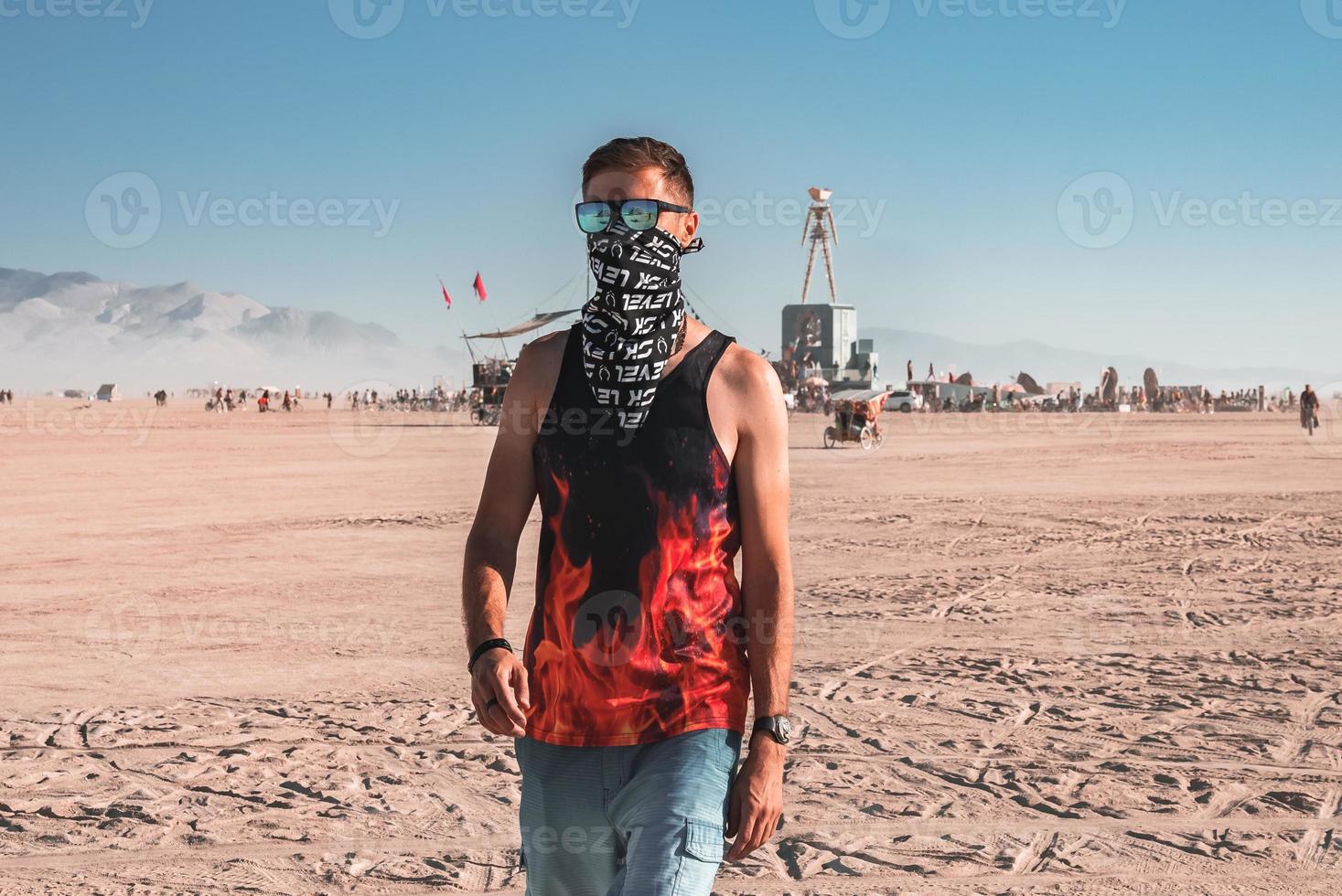 People walking towards sunset at a festival in the desert at the Burning Man Festival. photo