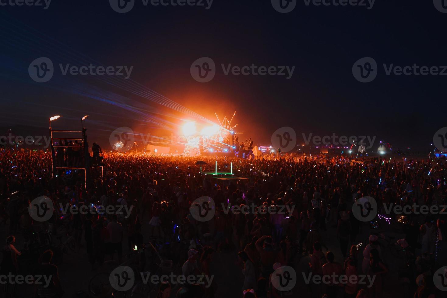 People walking towards sunset at a festival in the desert at the Burning Man Festival. photo