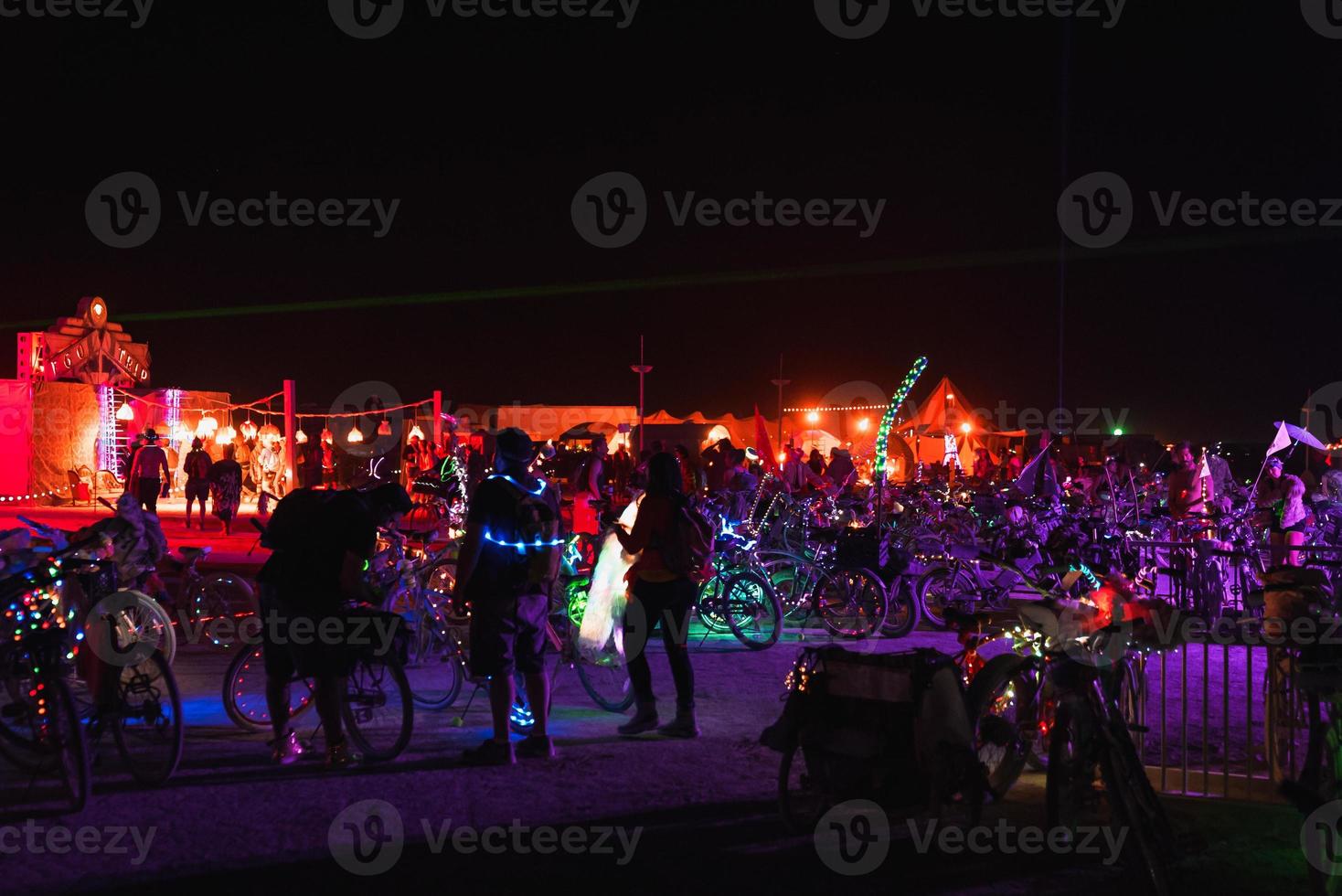 People walking towards sunset at a festival in the desert at the Burning Man Festival. photo