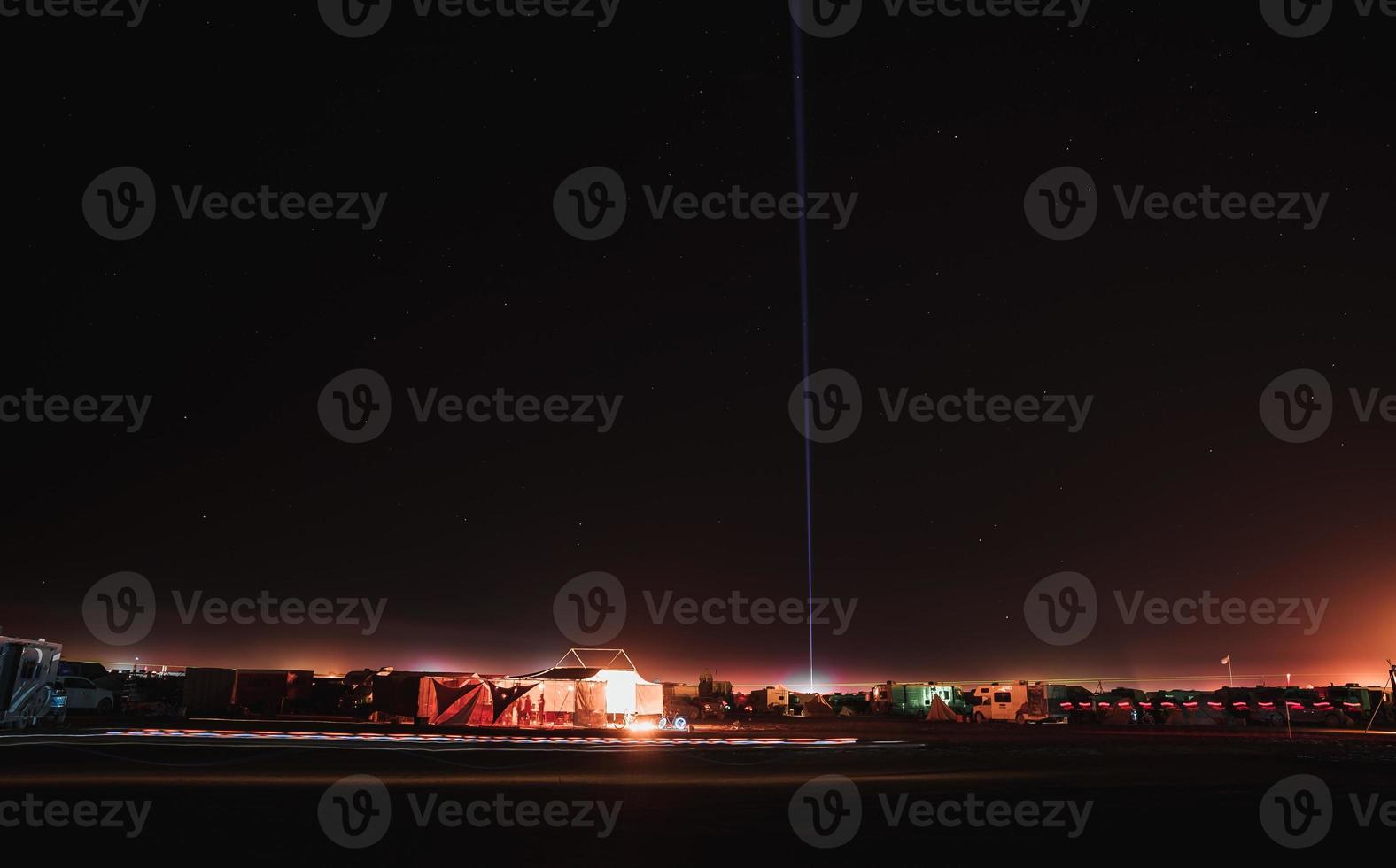 People walking towards sunset at a festival in the desert at the Burning Man Festival. photo