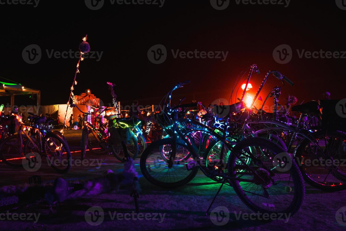 People walking towards sunset at a festival in the desert at the Burning Man Festival. photo