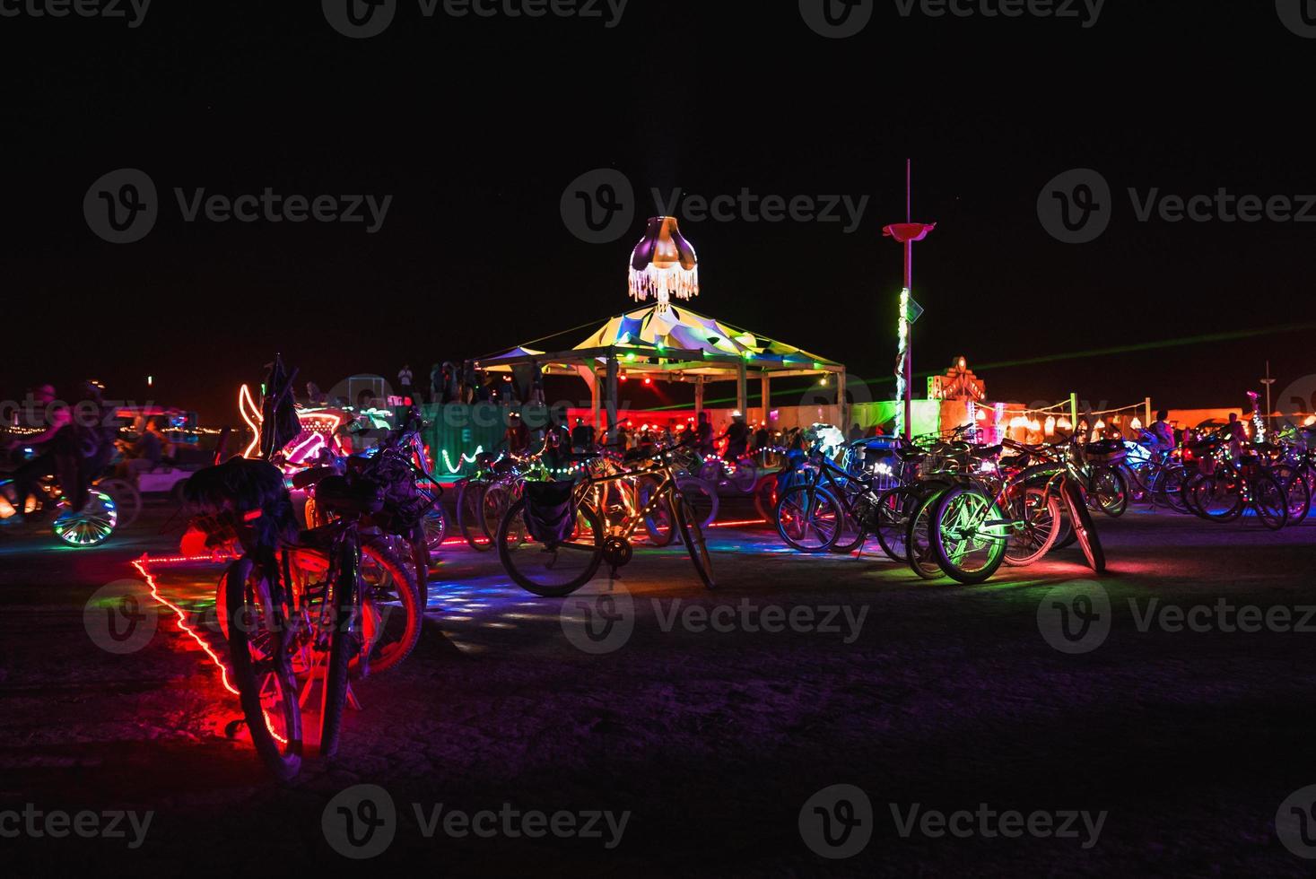 People walking towards sunset at a festival in the desert at the Burning Man Festival. photo