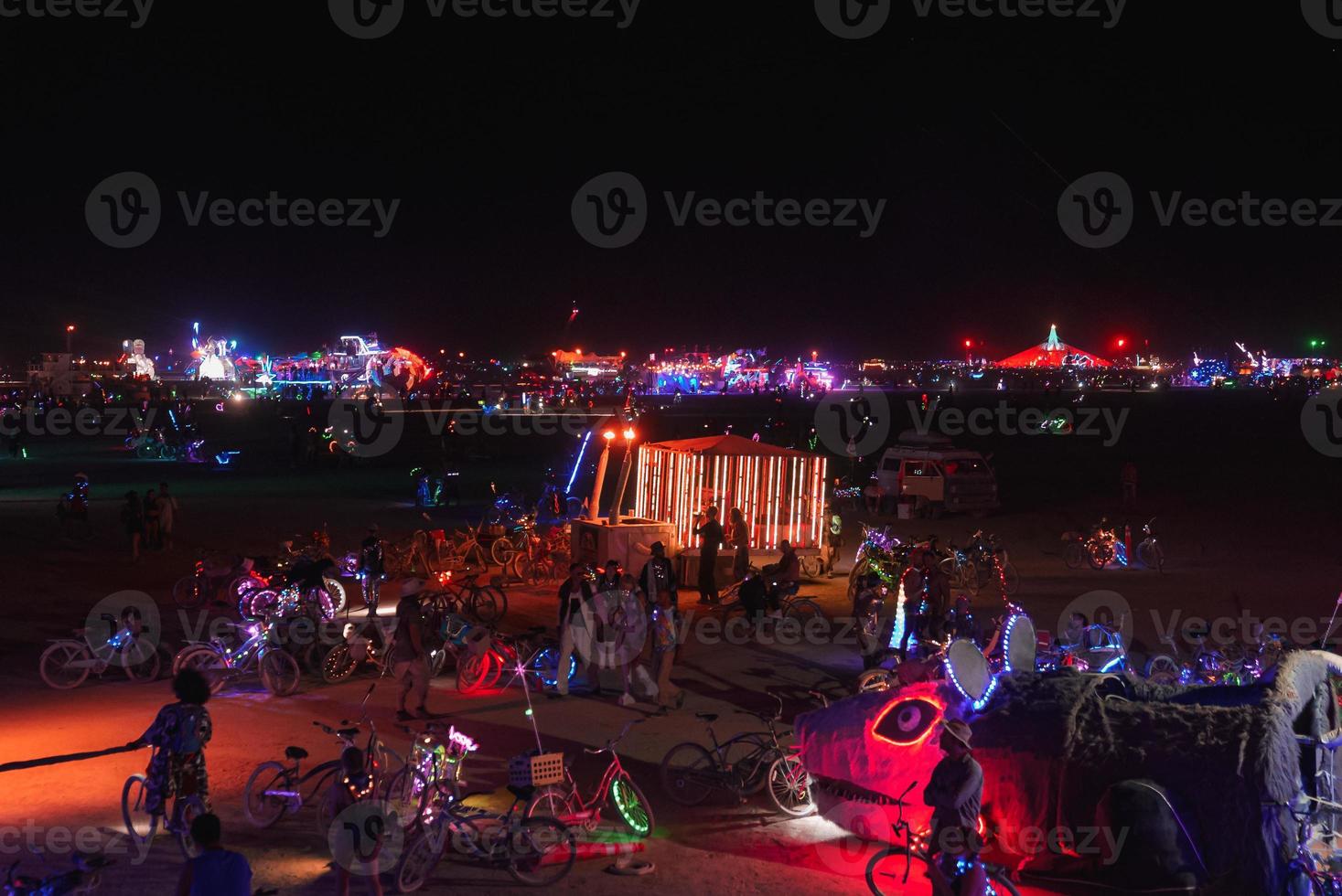 People walking towards sunset at a festival in the desert at the Burning Man Festival. photo