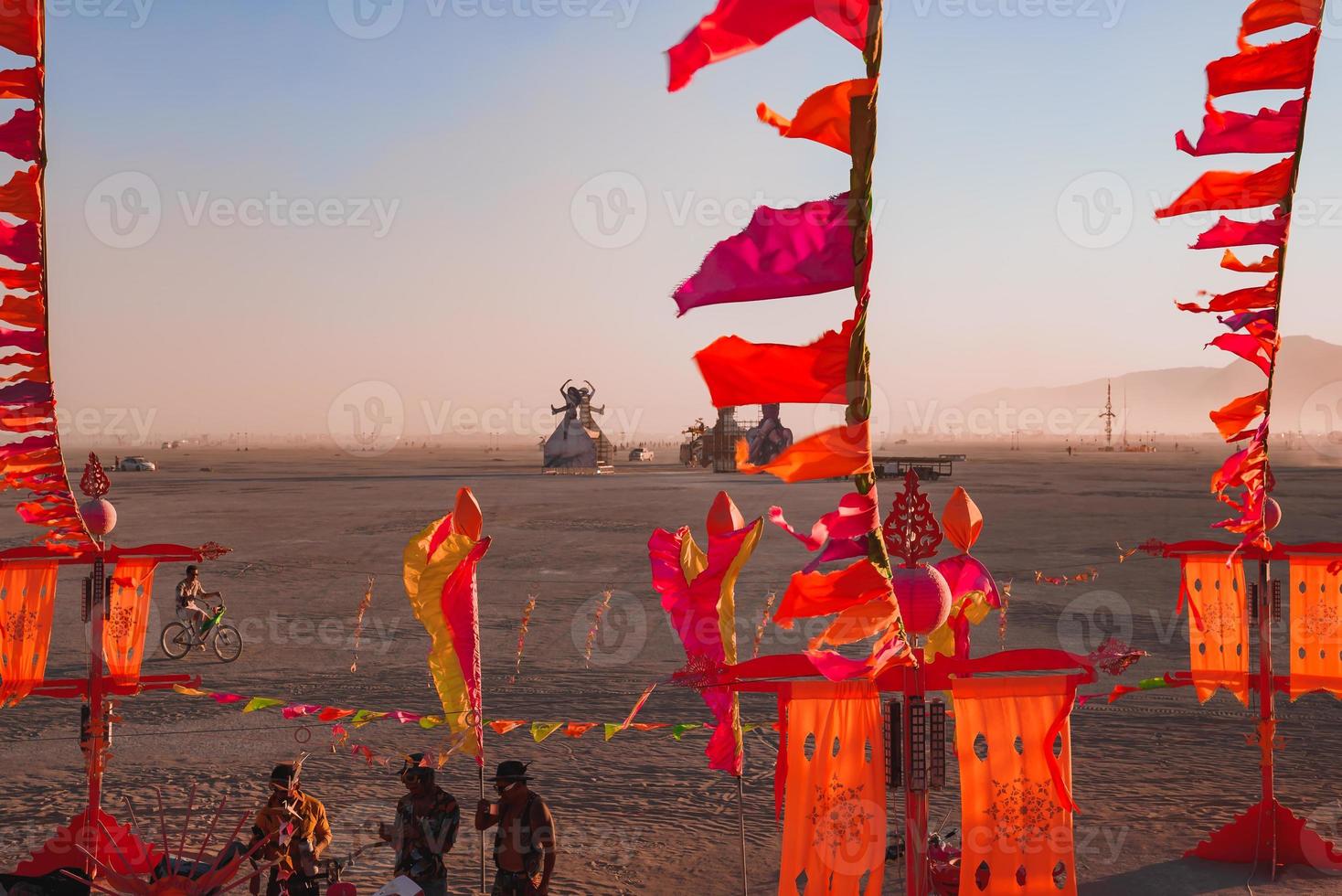People walking towards sunset at a festival in the desert at the Burning Man Festival. photo