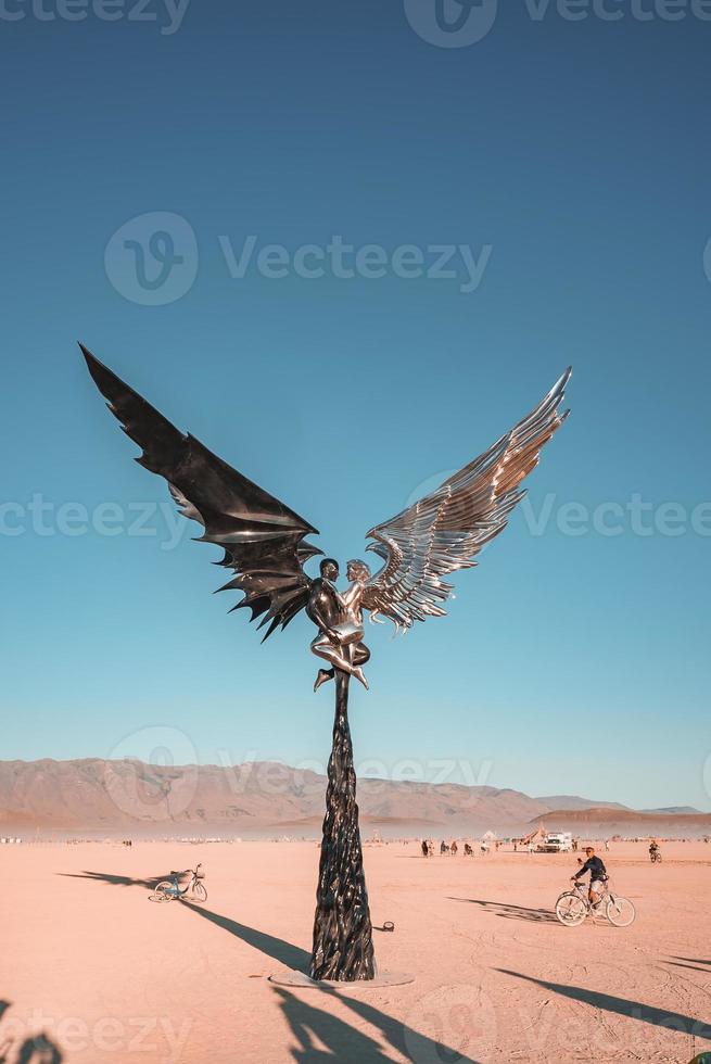 People walking towards sunset at a festival in the desert at the Burning Man Festival. photo