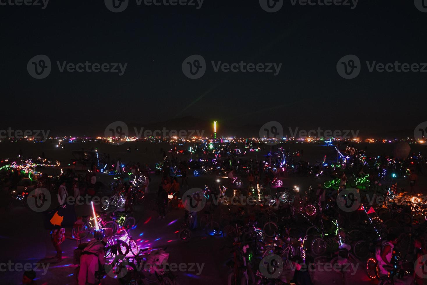 People walking towards sunset at a festival in the desert at the Burning Man Festival. photo