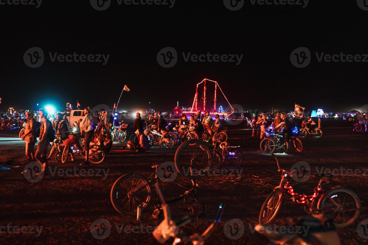 People walking towards sunset at a festival in the desert at the Burning Man Festival. photo