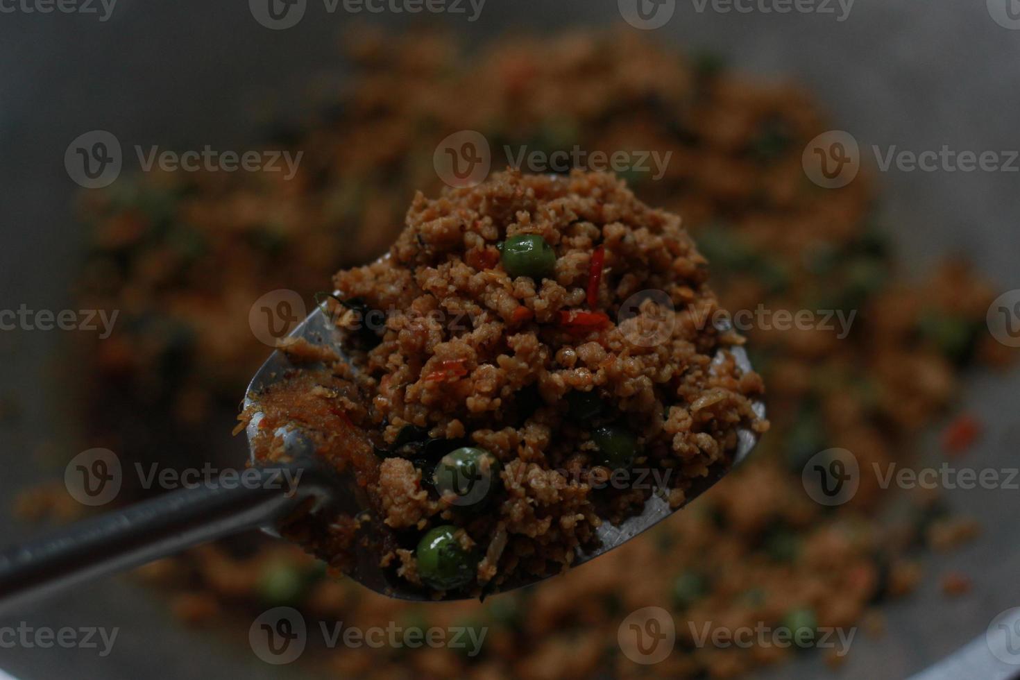 a close up of a side dish with stir-fried leunca and oncom photo