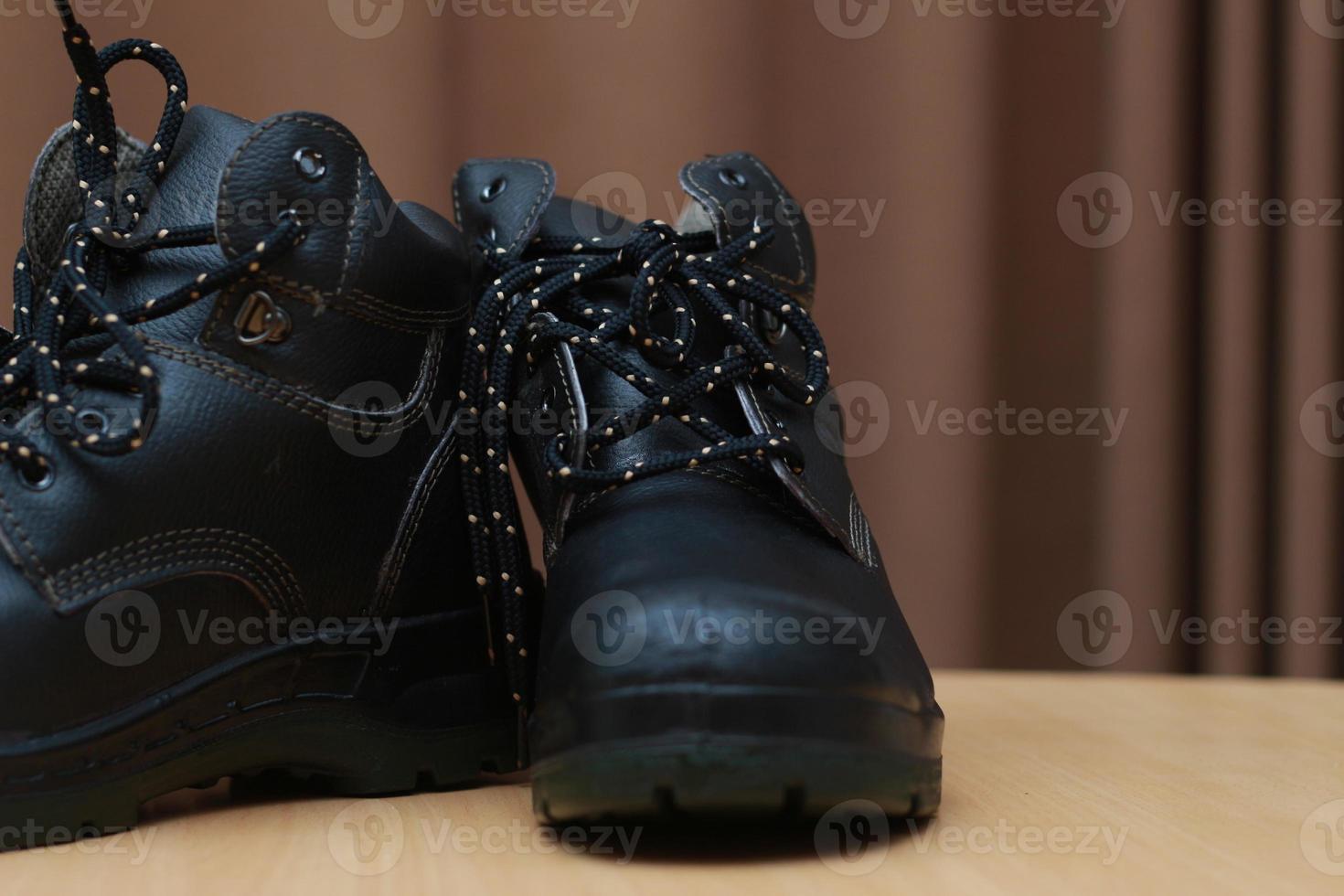 Detailed photo of a pair of safety shoes for work. Work protective equipment concept photo.