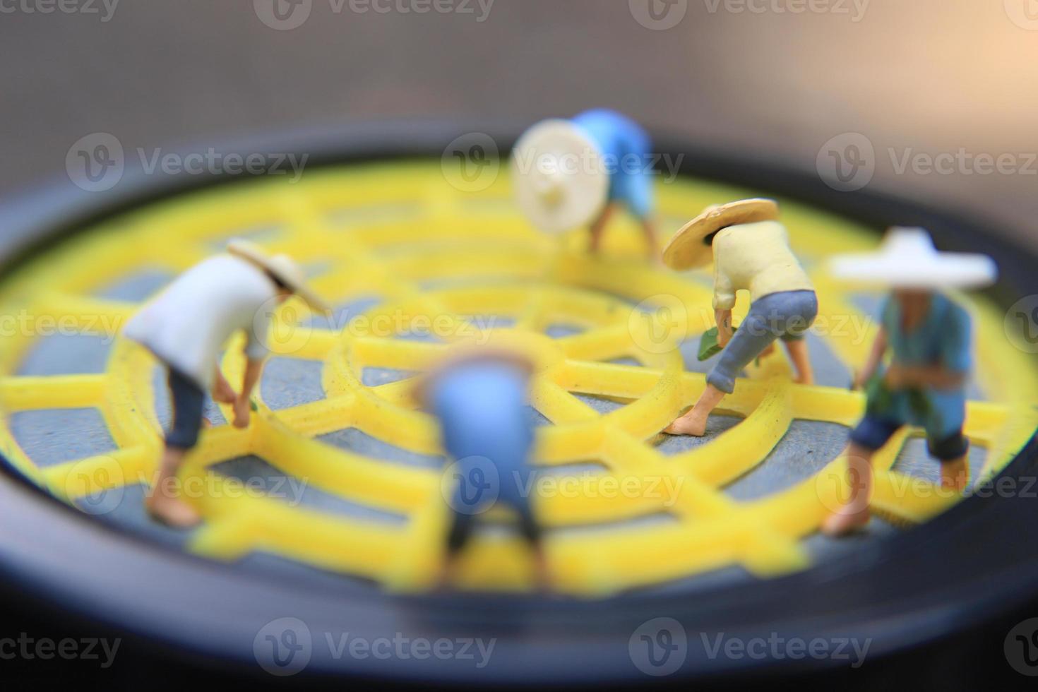 photo of a miniature figure with the concept of a farmer farming on a respirator.