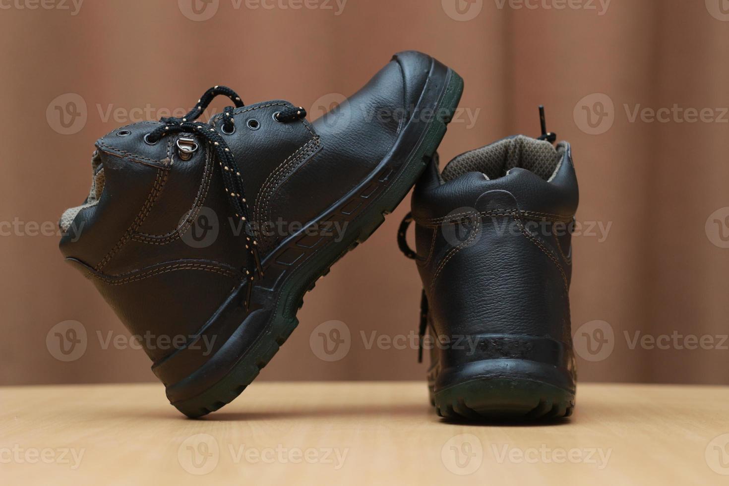 Detailed photo of a pair of safety shoes for work. Work protective equipment concept photo.