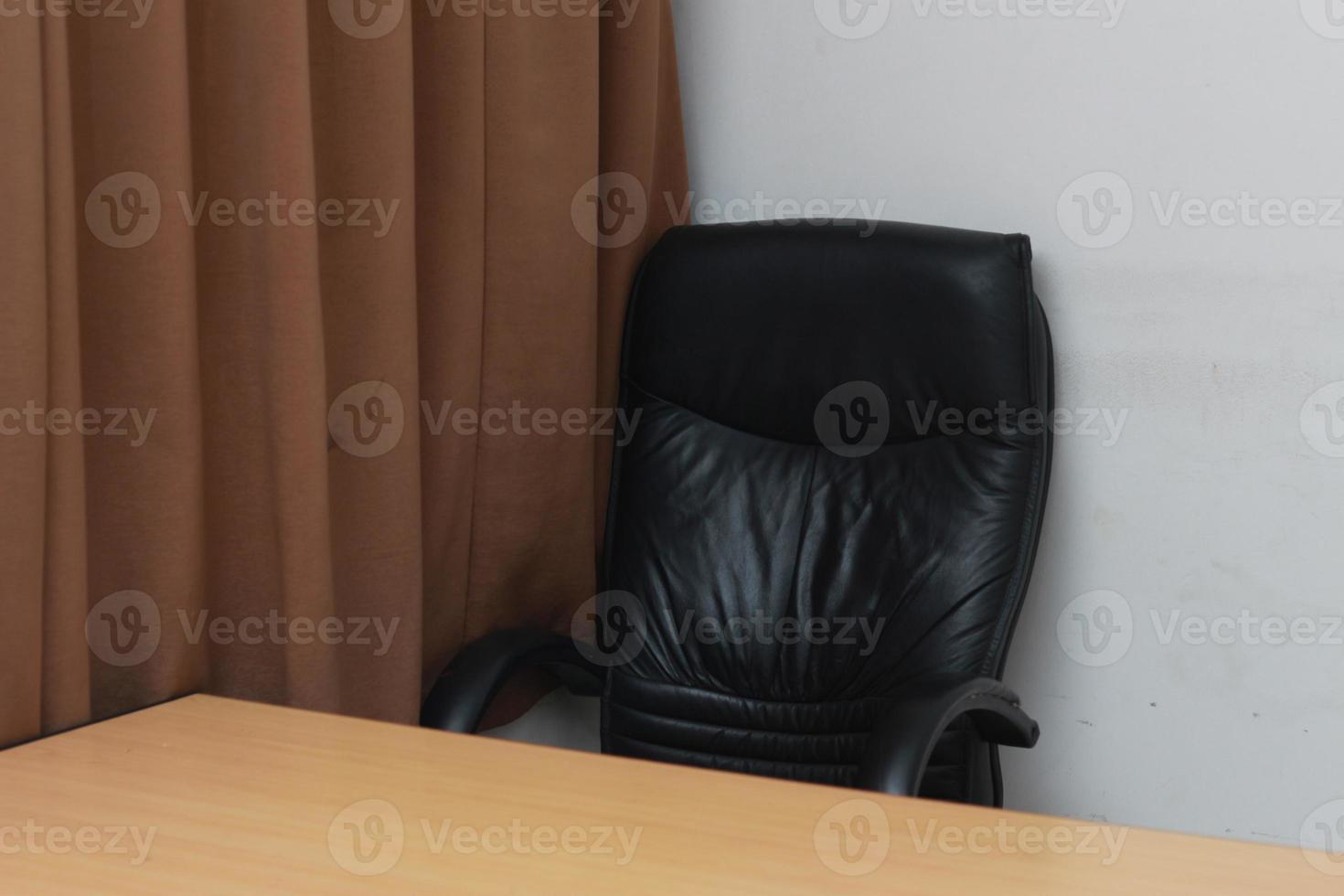 photo of a chair and desk with brown window curtains. Workspace concept photo.