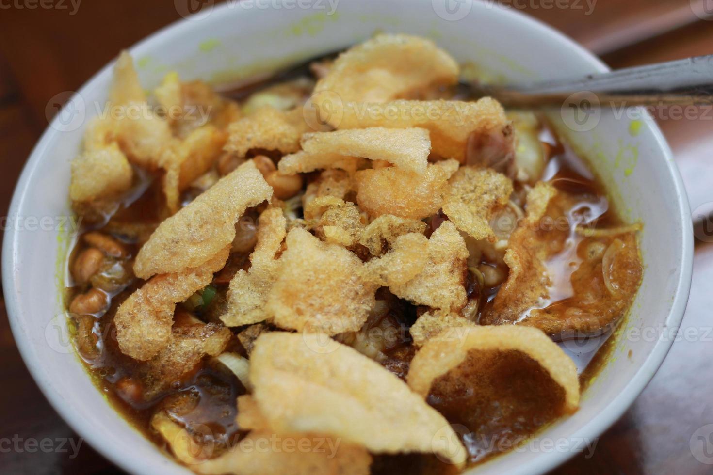 a close up of a ready-to-serve bowl of chicken porridge photo