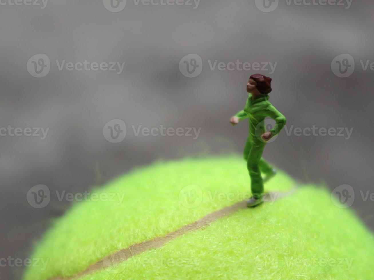 a close up of a miniature figure of a runner jogging on a baseball. sport photo concept.