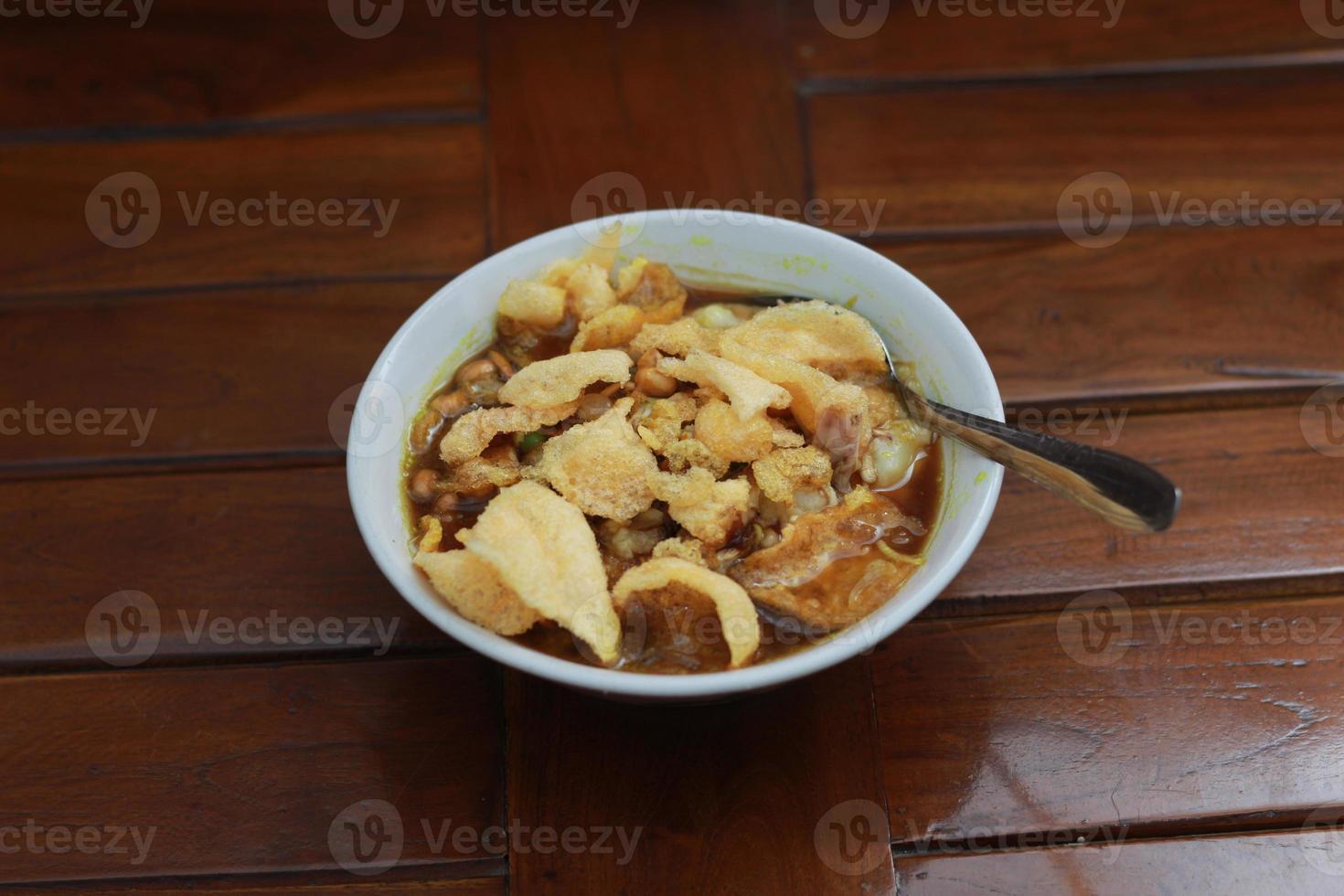 a close up of a ready-to-serve bowl of chicken porridge photo