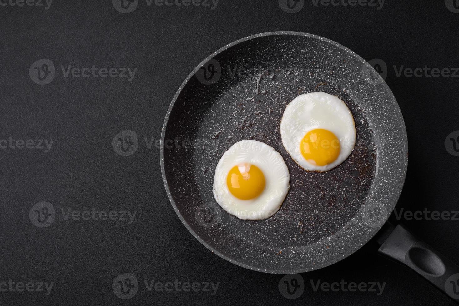 Delicious nutritious English breakfast with fried eggs and tomatoes photo