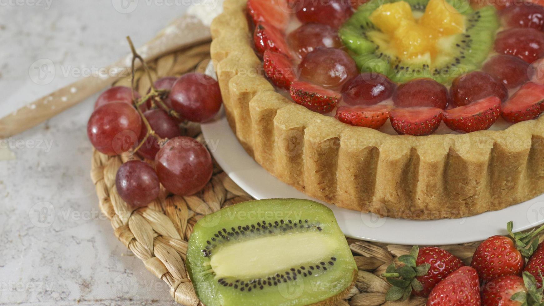 big fruit pie with toppings of strawberries, grapes, kiwi and pineapple. savory, sweet and fresh. Food concept photo. photo