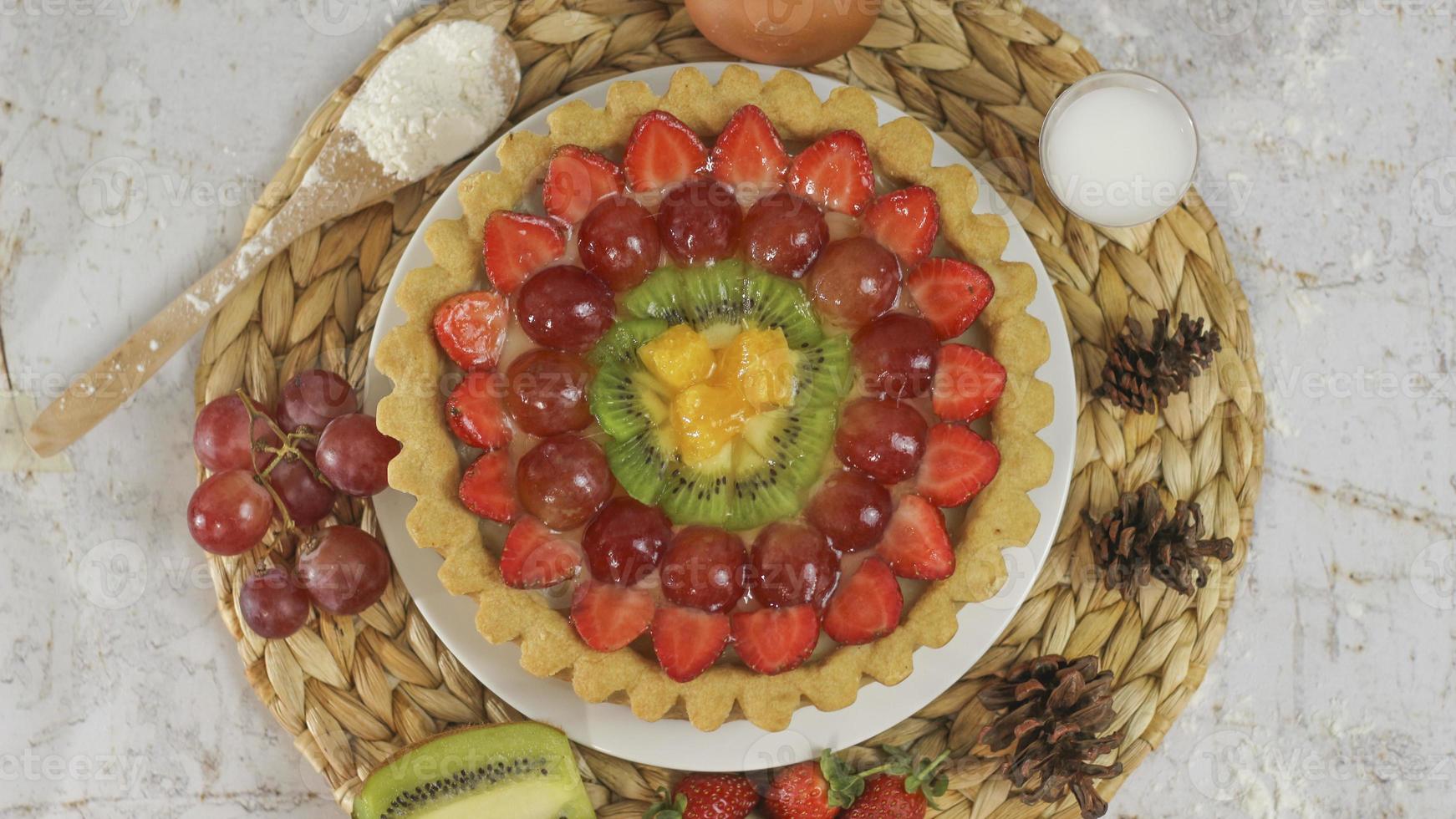 big fruit pie with toppings of strawberries, grapes, kiwi and pineapple. savory, sweet and fresh. Food concept photo. photo