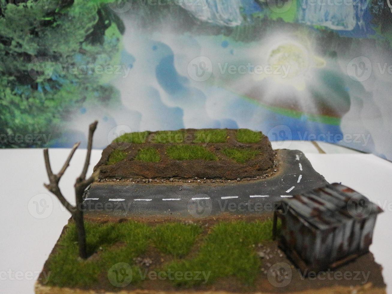 a close up of a diorama of a rice field scene and an old roadside house. miniature diorama photo concept.