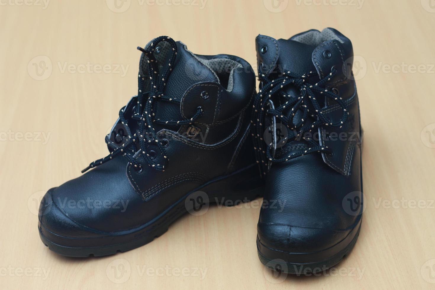 Detailed photo of a pair of safety shoes for work. Work protective equipment concept photo.