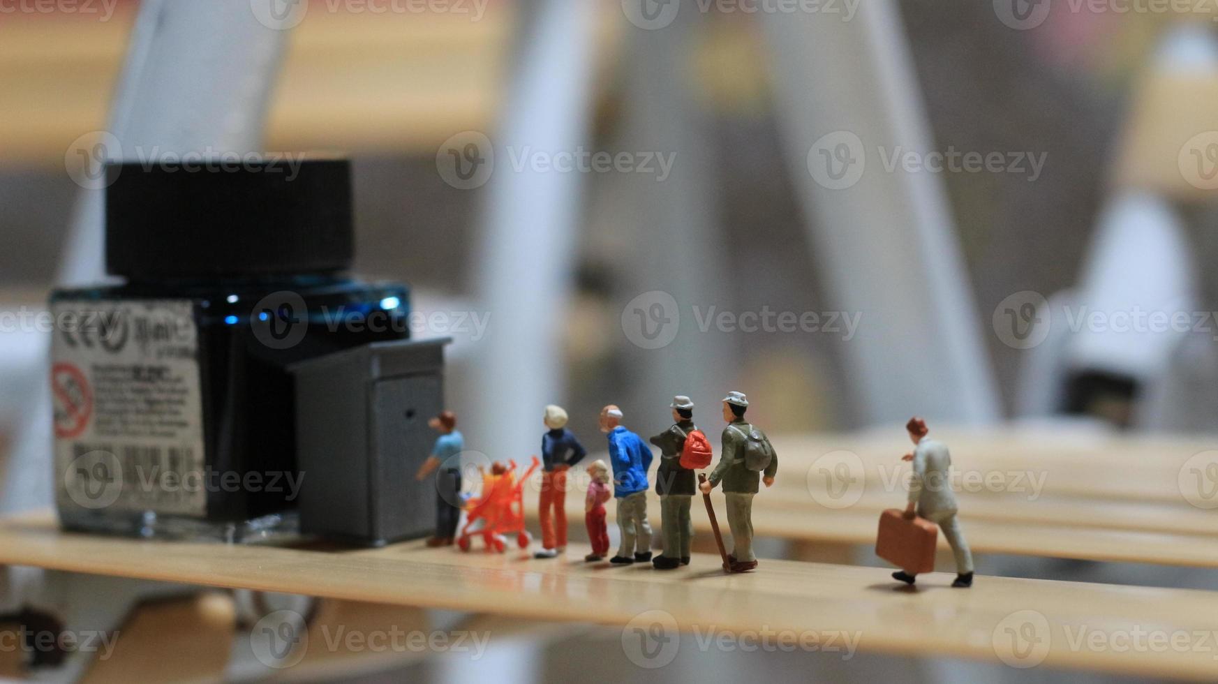 miniature figures of people queuing for public toilets. the concept of social etiquette. photo