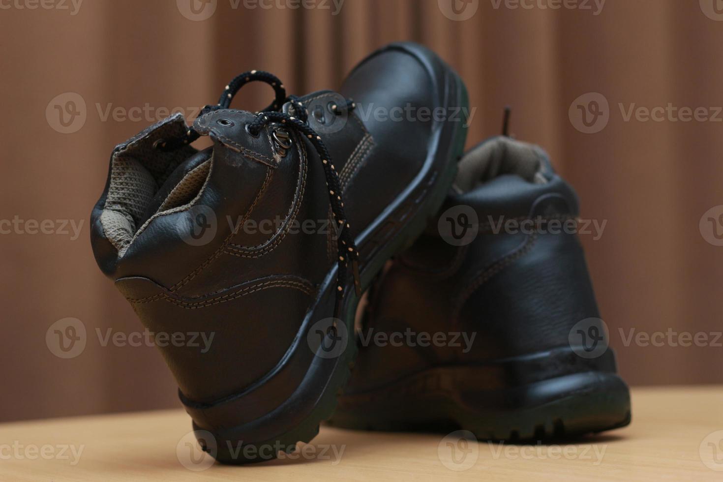 Detailed photo of a pair of safety shoes for work. Work protective equipment concept photo.