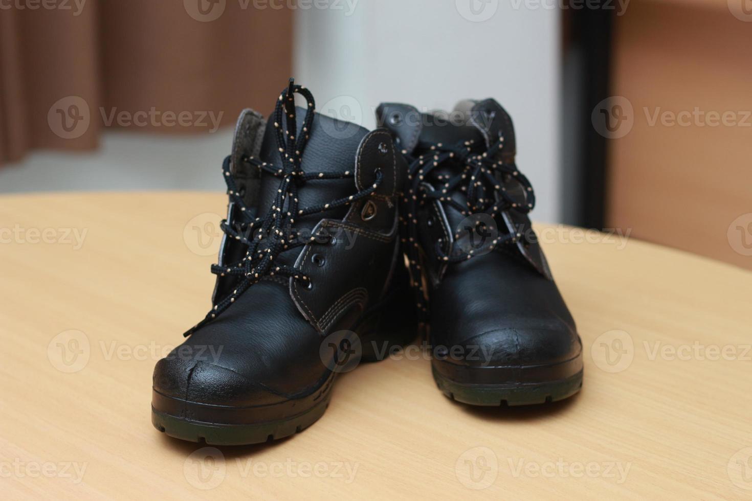 Detailed photo of a pair of safety shoes for work. Work protective equipment concept photo.