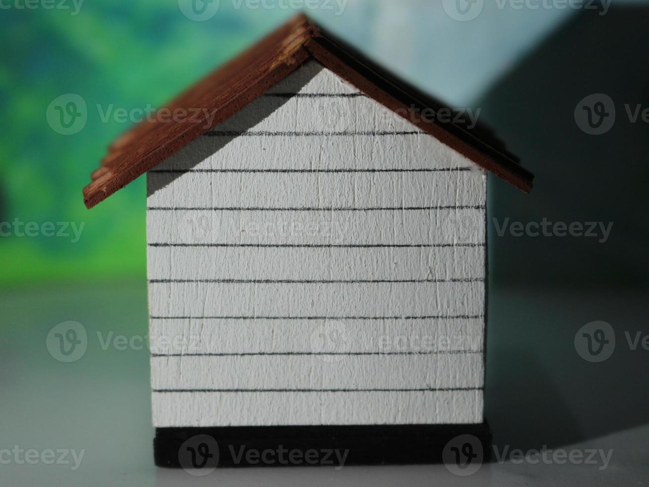 a close up of a miniature figure of a house seen from one side. simple home photo concept.