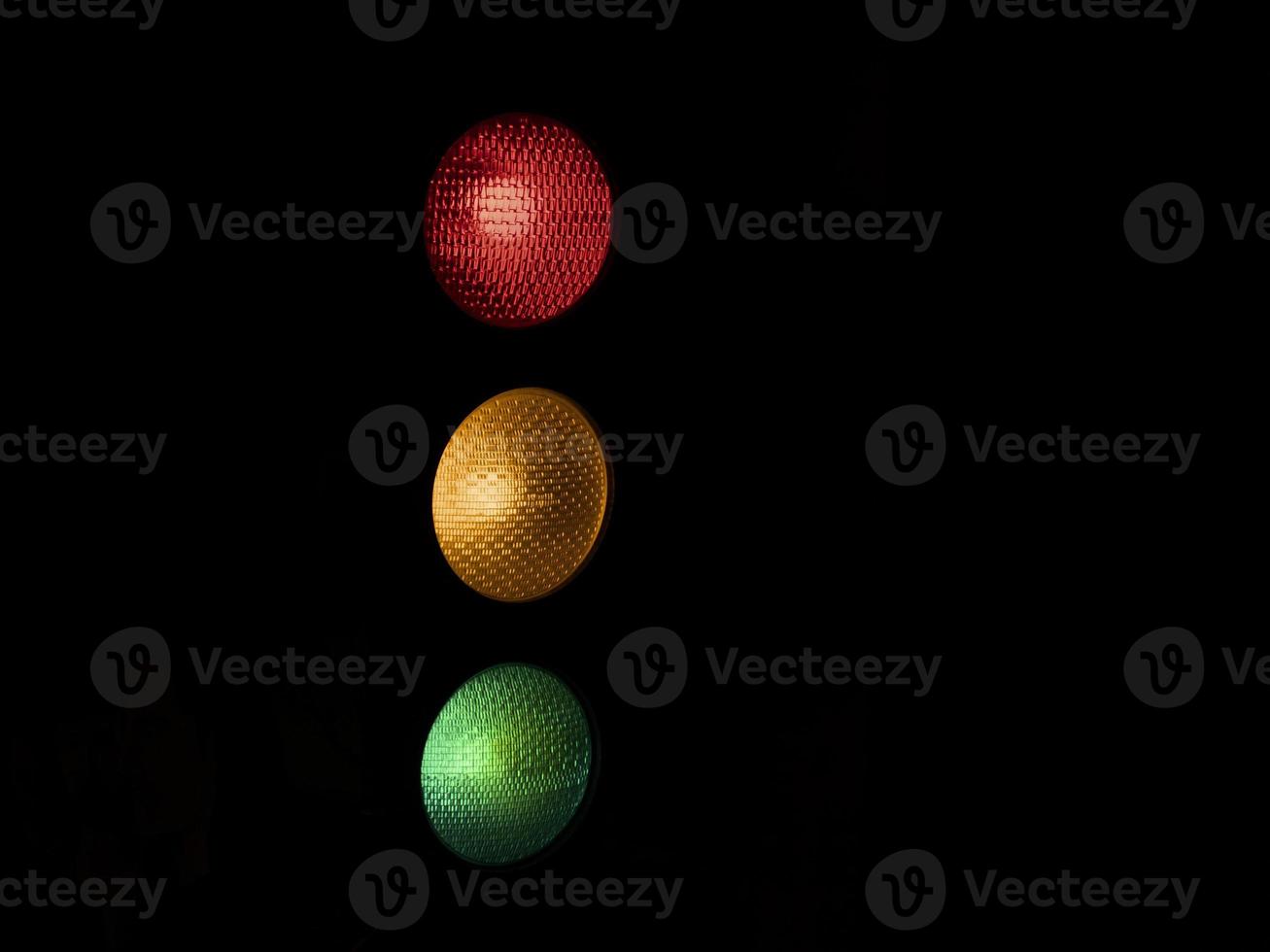 traffic light red yellow green isolated on black photo