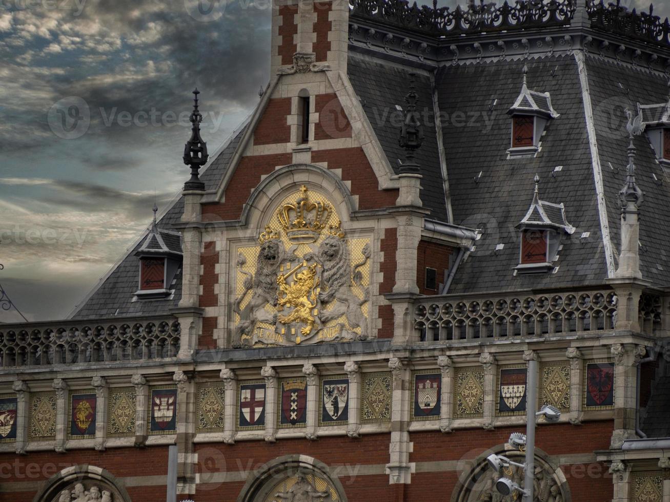Central station in amsterdam old houses view from canals photo