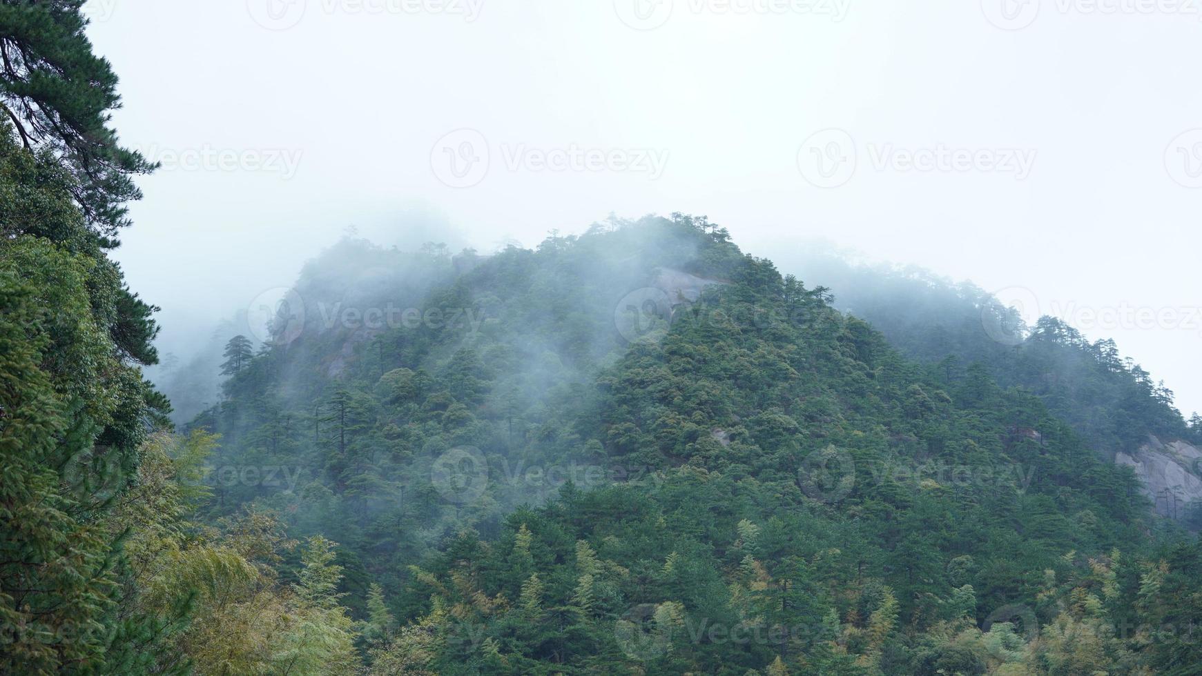 The beautiful mountains view with the fog during the rainy day photo