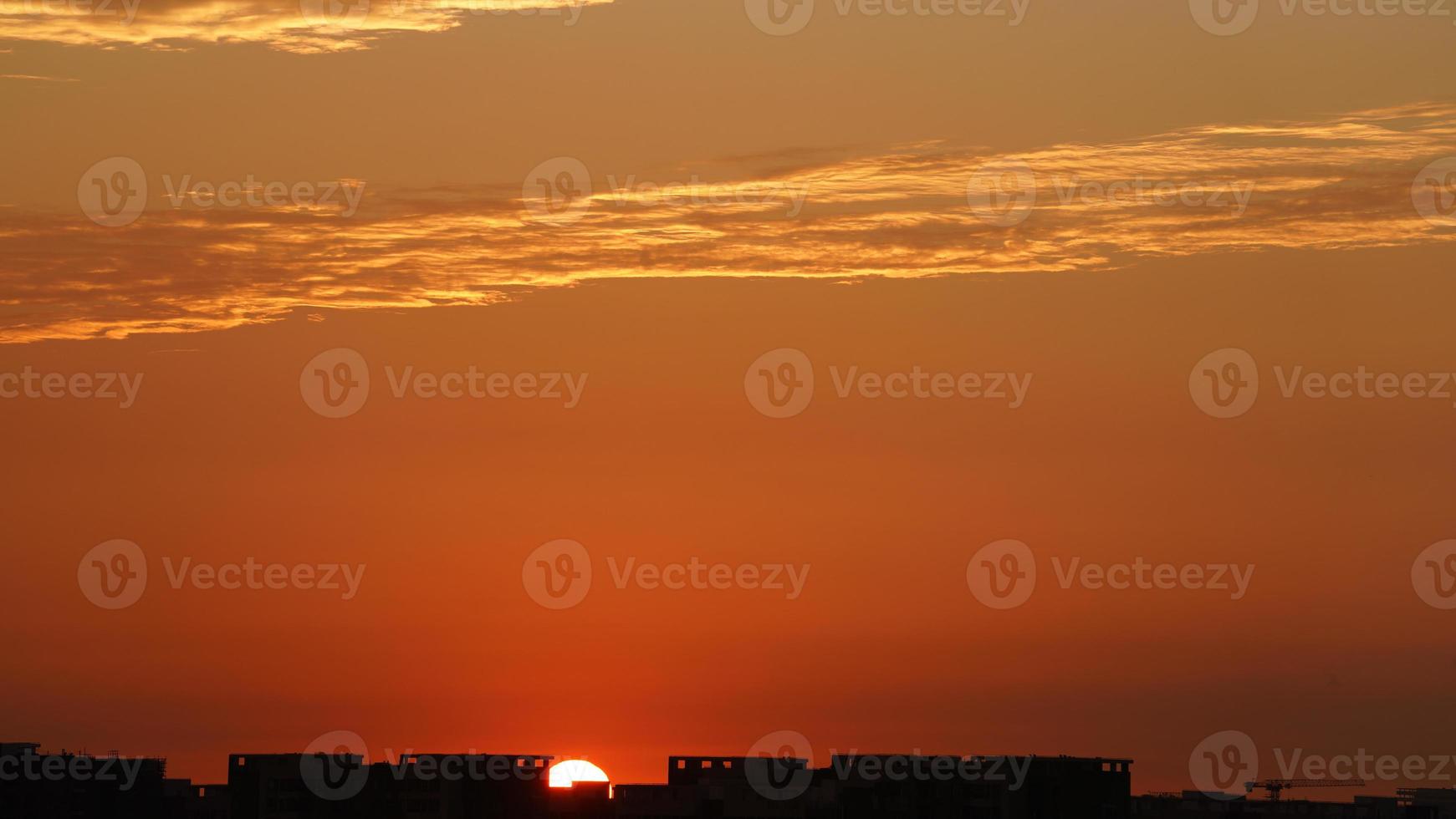 The beautiful sunset sky view with the colorful clouds and warm lights in the sky photo