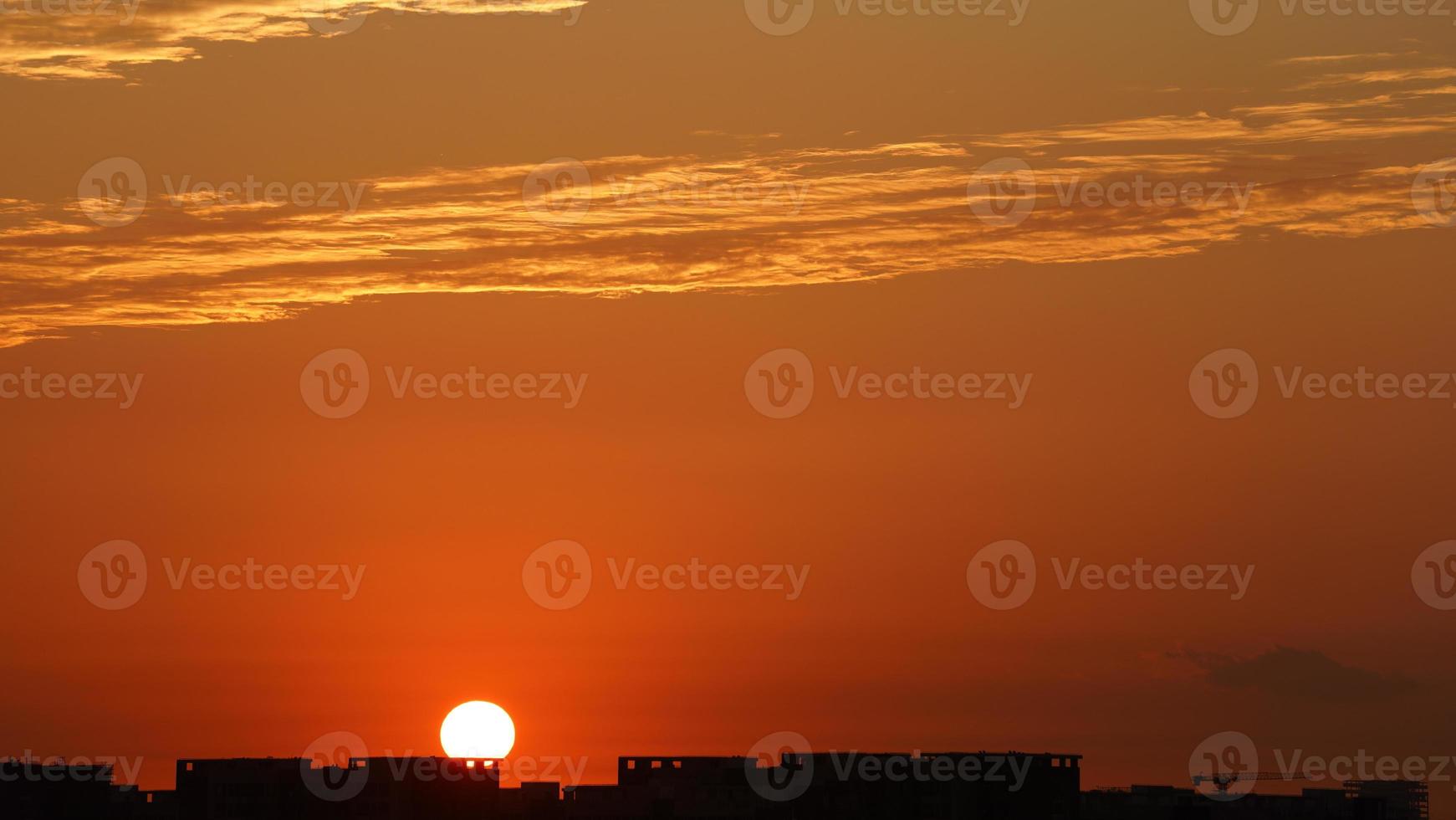 The beautiful sunset sky view with the colorful clouds and warm lights in the sky photo