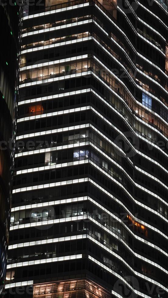 The skyscraper night view with the lights on at night photo