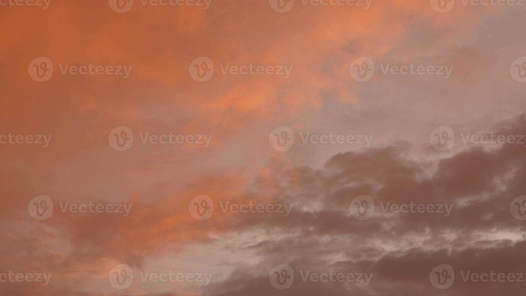 The beautiful sunset sky view with the colorful clouds and warm lights in the sky photo