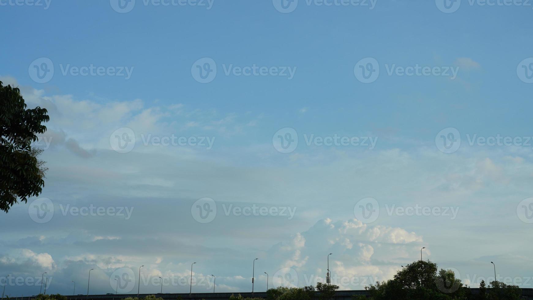 The summer sky view with the white clouds and blue sky as background photo